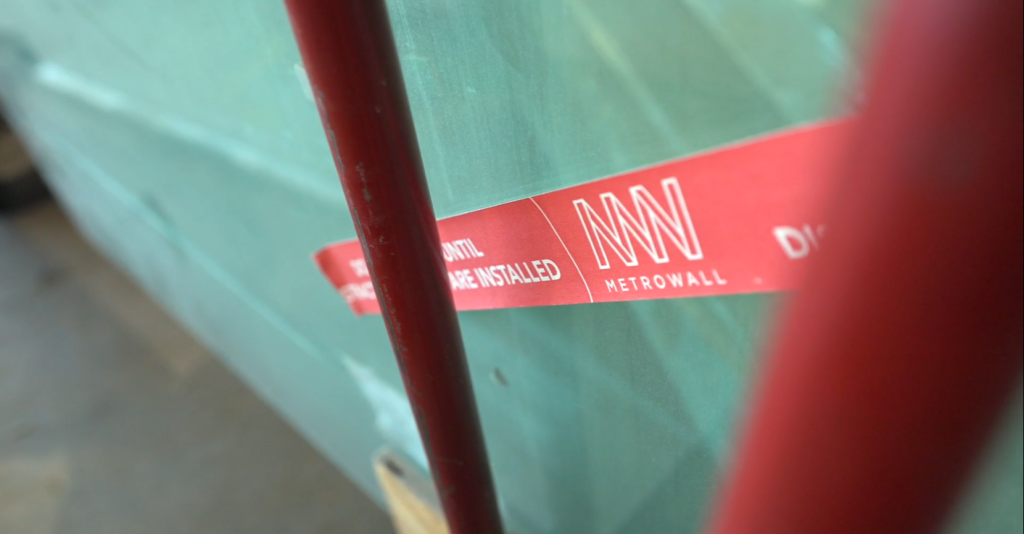 Glass with red tape to promote safety on jobsite.